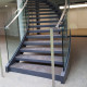 YSOGLASS escalier métallique intérieur balancé avec rampant verre avec main courante en plat inox